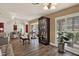 Bright living area featuring plantation shutters, wood floors, and a display cabinet at 8516 Wooddrift Dr, Tampa, FL 33615