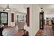 Open-concept living room with terra-cotta floors, wooden floors, archways, and a view of the kitchen at 8516 Wooddrift Dr, Tampa, FL 33615