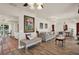 Inviting living room showcasing wood floors, a decorative fireplace, and archways to other rooms at 8516 Wooddrift Dr, Tampa, FL 33615