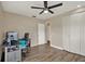 Home office with luxury vinyl tile floors, ceiling fan, closet, and computer at 8516 Wooddrift Dr, Tampa, FL 33615