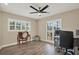 Home office featuring luxury vinyl tile floors, ceiling fan, and shuttered windows at 8516 Wooddrift Dr, Tampa, FL 33615