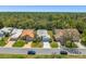 A scenic view of single-story homes nestled in a lush, wooded neighborhood under a bright blue sky at 9398 Mississippi Run, Weeki Wachee, FL 34613