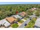 An aerial view shows the neighborhood street and surrounding trees at 9398 Mississippi Run, Weeki Wachee, FL 34613