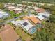Picturesque aerial view of a neighborhood with houses featuring screened pools and solar panels at 9398 Mississippi Run, Weeki Wachee, FL 34613