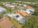 Aerial view highlights the pool, solar panels, and the neighborhood at 9398 Mississippi Run, Weeki Wachee, FL 34613