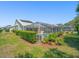 The exterior shows a screened pool, covered patio, and neatly trimmed perimeter shrubs at 9398 Mississippi Run, Weeki Wachee, FL 34613
