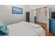 Bright bedroom features a relaxing color palette with a view to the hallway bathroom at 9398 Mississippi Run, Weeki Wachee, FL 34613
