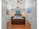 Comfortable bedroom featuring hardwood floors, a ceiling fan, and dual nightstands at 9398 Mississippi Run, Weeki Wachee, FL 34613