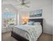 Cozy bedroom with a large window, comfortable bed, and charming nautical-themed decor at 9398 Mississippi Run, Weeki Wachee, FL 34613