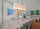Dining room featuring a stylish chandelier, artwork, and adjacent office space with a cohesive design at 9398 Mississippi Run, Weeki Wachee, FL 34613