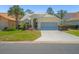 Charming single-story home with a well-manicured front yard, mature landscaping, and a two-car garage at 9398 Mississippi Run, Weeki Wachee, FL 34613
