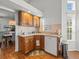 Functional kitchen area featuring a sink, dishwasher, and window that adds natural light, creating a welcoming space at 9398 Mississippi Run, Weeki Wachee, FL 34613