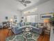 Inviting living room showcasing a cozy sectional, stylish decor, and open layout for easy entertaining at 9398 Mississippi Run, Weeki Wachee, FL 34613