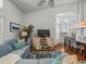 Comfortable living room featuring plush seating, large windows, and open access to the dining area at 9398 Mississippi Run, Weeki Wachee, FL 34613