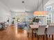 Open-concept living and dining area with hardwood floors and lots of natural light at 9398 Mississippi Run, Weeki Wachee, FL 34613