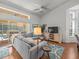 Open-concept living space with a plush sectional sofa, leading out to the pool area for seamless indoor-outdoor living at 9398 Mississippi Run, Weeki Wachee, FL 34613