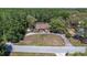 An aerial view showcases this home's mature landscaping, circular driveway, and private wooded surroundings at 10134 Buck Dr, New Port Richey, FL 34654