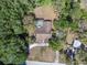 Aerial view of the home with a screened pool surrounded by trees showcases an estate with privacy and seclusion at 10134 Buck Dr, New Port Richey, FL 34654