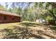View of the back of the house with mature landscaping and lush trees at 10134 Buck Dr, New Port Richey, FL 34654