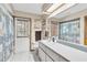 Clean bathroom features a wide vanity and door to the outside at 10134 Buck Dr, New Port Richey, FL 34654