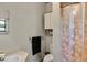 This bathroom features a shower with patterned curtain, and a white cabinet for storage at 10134 Buck Dr, New Port Richey, FL 34654