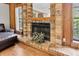 A traditional brick fireplace, accented with wood paneling, serves as a focal point in the living room at 10134 Buck Dr, New Port Richey, FL 34654