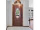 Elegant front door with decorative glass, natural wood trim and tiled entry at 10134 Buck Dr, New Port Richey, FL 34654