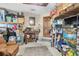 Cluttered garage with tools, boxes and a leather couch for relaxation at 10134 Buck Dr, New Port Richey, FL 34654