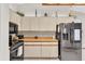 Modern kitchen featuring stainless steel appliances and white cabinetry at 10134 Buck Dr, New Port Richey, FL 34654