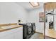 This spacious laundry room has modern appliances, a sink, shelving, and natural light at 10134 Buck Dr, New Port Richey, FL 34654