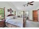 Spacious main bedroom boasts a four-poster bed and patio access at 10134 Buck Dr, New Port Richey, FL 34654