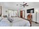 Bright bedroom with a ceiling fan, desk, and access to the outdoors at 10134 Buck Dr, New Port Richey, FL 34654