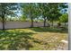 Well-maintained backyard featuring a lush lawn, mature trees, and a white privacy fence at 10780 43Rd N St # 702, Clearwater, FL 33762