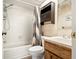 Full bathroom featuring tub-shower combo with vanity, storage cabinet and tile flooring at 10780 43Rd N St # 702, Clearwater, FL 33762