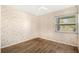 Cozy bedroom with wood-look flooring, ceiling fan and large window at 10780 43Rd N St # 702, Clearwater, FL 33762