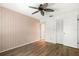 Well-lit bedroom with hardwood flooring and closet storage at 10780 43Rd N St # 702, Clearwater, FL 33762