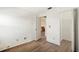 Bedroom with wood-look floors, closet, and view into adjacent room at 10780 43Rd N St # 702, Clearwater, FL 33762