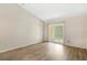 Bedroom with an open sliding glass doors to the outside area and hardwood flooring at 10780 43Rd N St # 702, Clearwater, FL 33762
