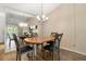 Dining room with a mirrored wall and an elegant chandelier above a wood dining table at 10780 43Rd N St # 702, Clearwater, FL 33762