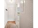 Bright hallway featuring laminate flooring and decorative wallpaper at 10780 43Rd N St # 702, Clearwater, FL 33762