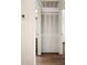 Hallway access to a half bathroom and closet with louvered doors for ventilation at 10780 43Rd N St # 702, Clearwater, FL 33762