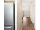 View of an open hallway and modern kitchen appliances including a stainless steel refrigerator at 10780 43Rd N St # 702, Clearwater, FL 33762