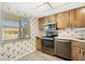 Functional kitchen featuring wood cabinetry and stainless steel appliances at 10780 43Rd N St # 702, Clearwater, FL 33762
