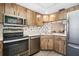 Functional kitchen featuring stainless steel appliances and wood cabinetry at 10780 43Rd N St # 702, Clearwater, FL 33762
