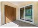 View of the patio with double doors, large window, and view of the backyard at 10780 43Rd N St # 702, Clearwater, FL 33762