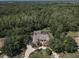A sweeping aerial view showcases the home's circular driveway and extensive landscaping at 10808 Alico Pass, New Port Richey, FL 34655