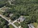 Lush trees surround a sprawling home with pool and circular driveway at 10808 Alico Pass, New Port Richey, FL 34655