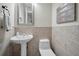 Charming powder room features tile accents, a pedestal sink, toilet, and decorative wall art at 10808 Alico Pass, New Port Richey, FL 34655