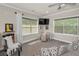Cozy bonus room features plush carpet, two large windows, a ceiling fan, and neutral décor at 10808 Alico Pass, New Port Richey, FL 34655