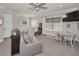 Bonus room features a large sofa, ceiling fan, a table with seating, and neutral decor at 10808 Alico Pass, New Port Richey, FL 34655